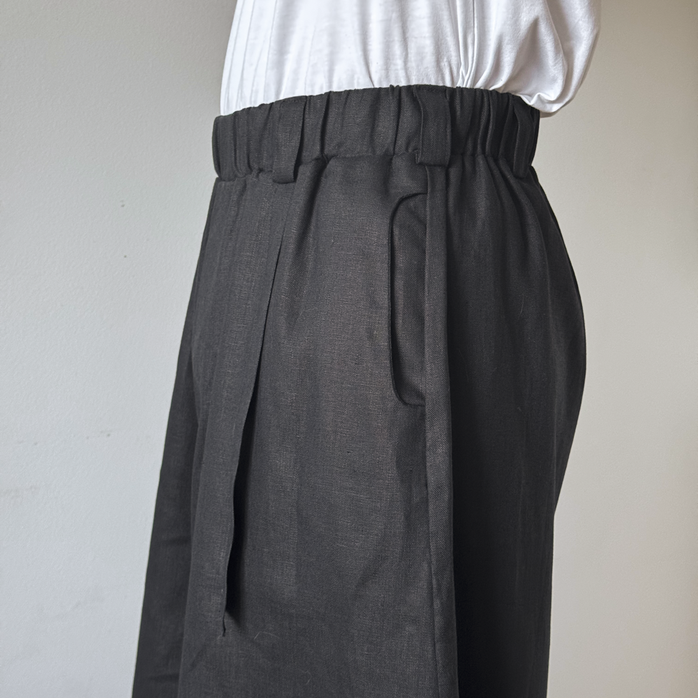 Black Wide pants worn by a person on a plain background