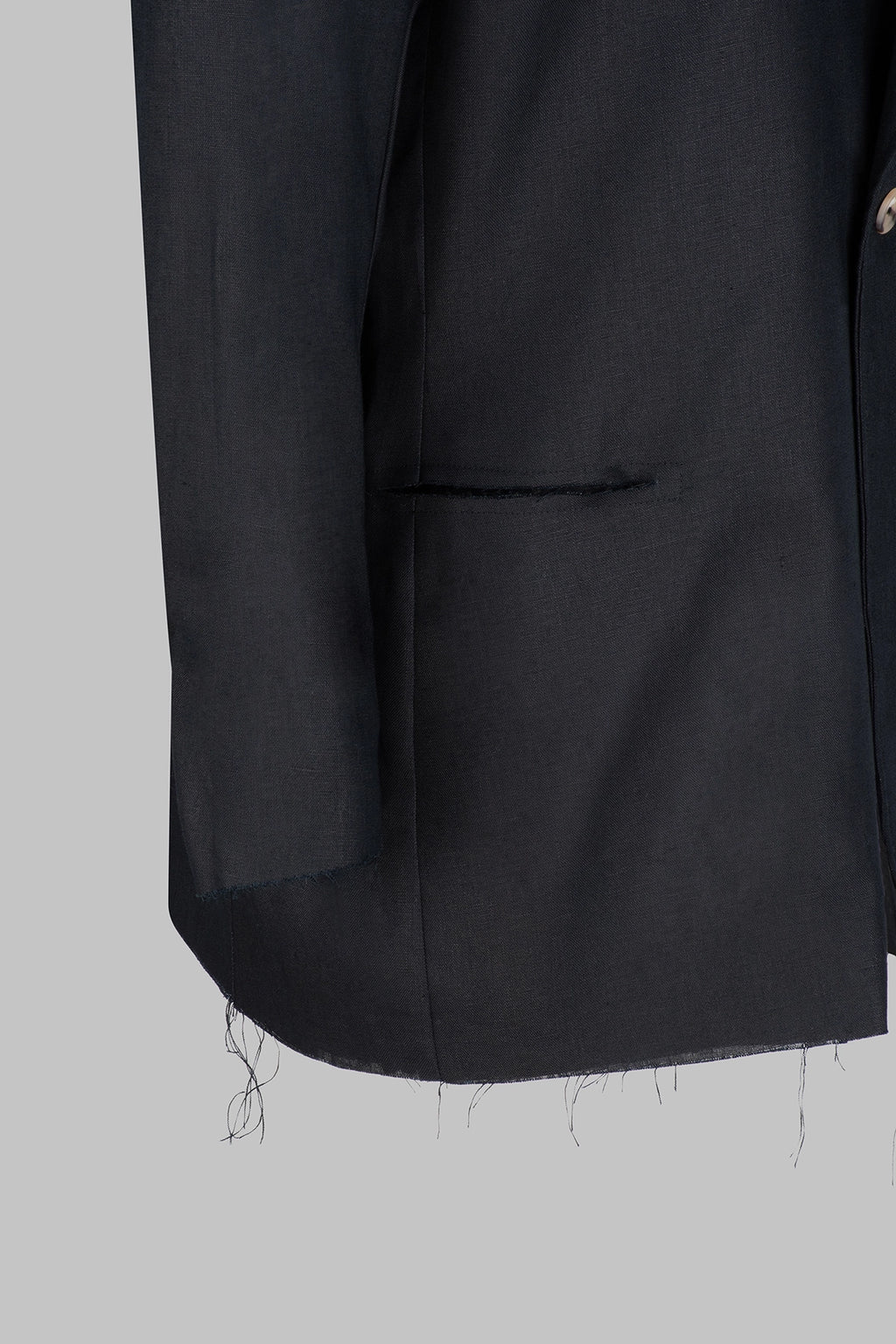 Closeup view of the Studio Luho deconstructed European linen blazer in black.