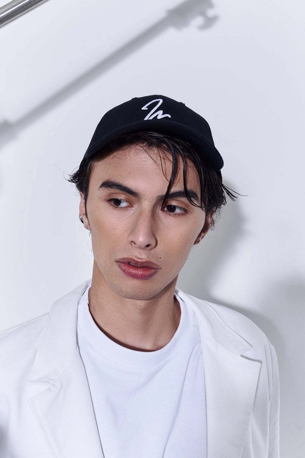 Model wearing the Studio Luho Trucker Cap.