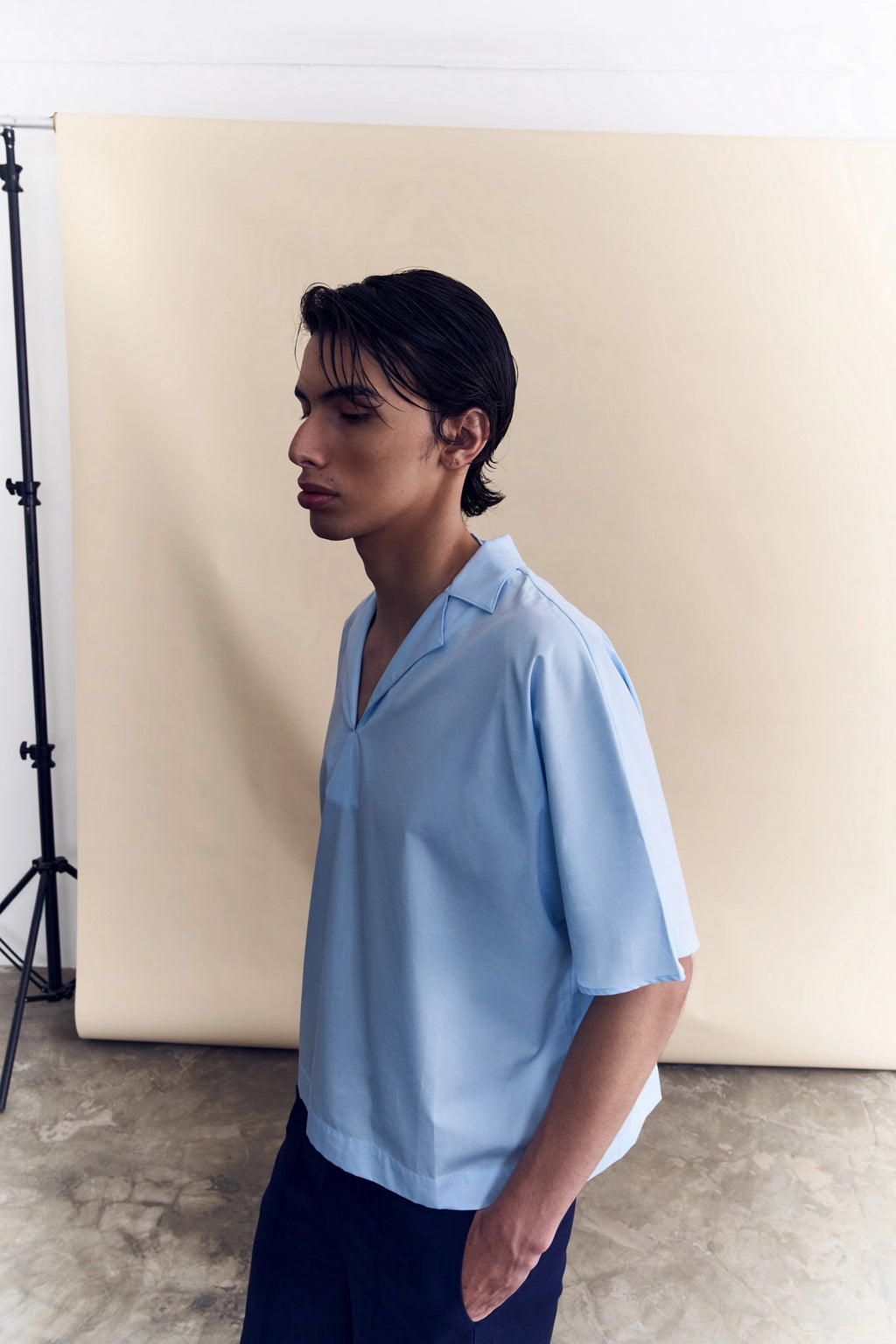 Model wearing the light blue short sleeve poplin shirt from Studio Luho.