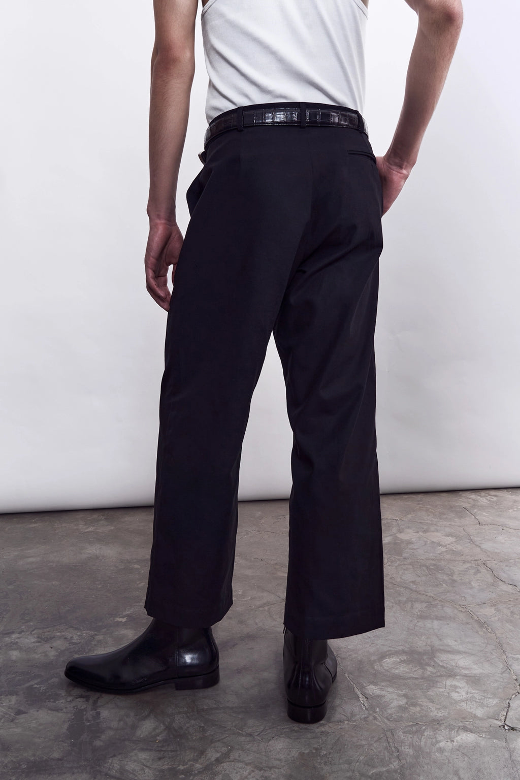 Model wearing the Studio Luho black cotton trousers, a Melbourne-made relaxed fit pleated pant.
