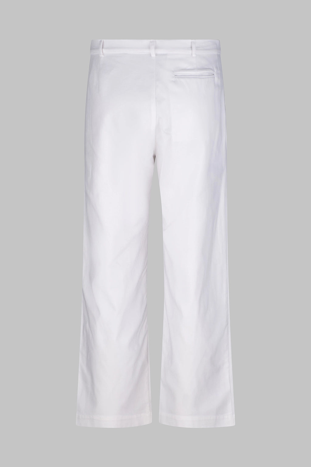 Back view of the Studio Luho relaxed fit pleated cotton trousers in white.