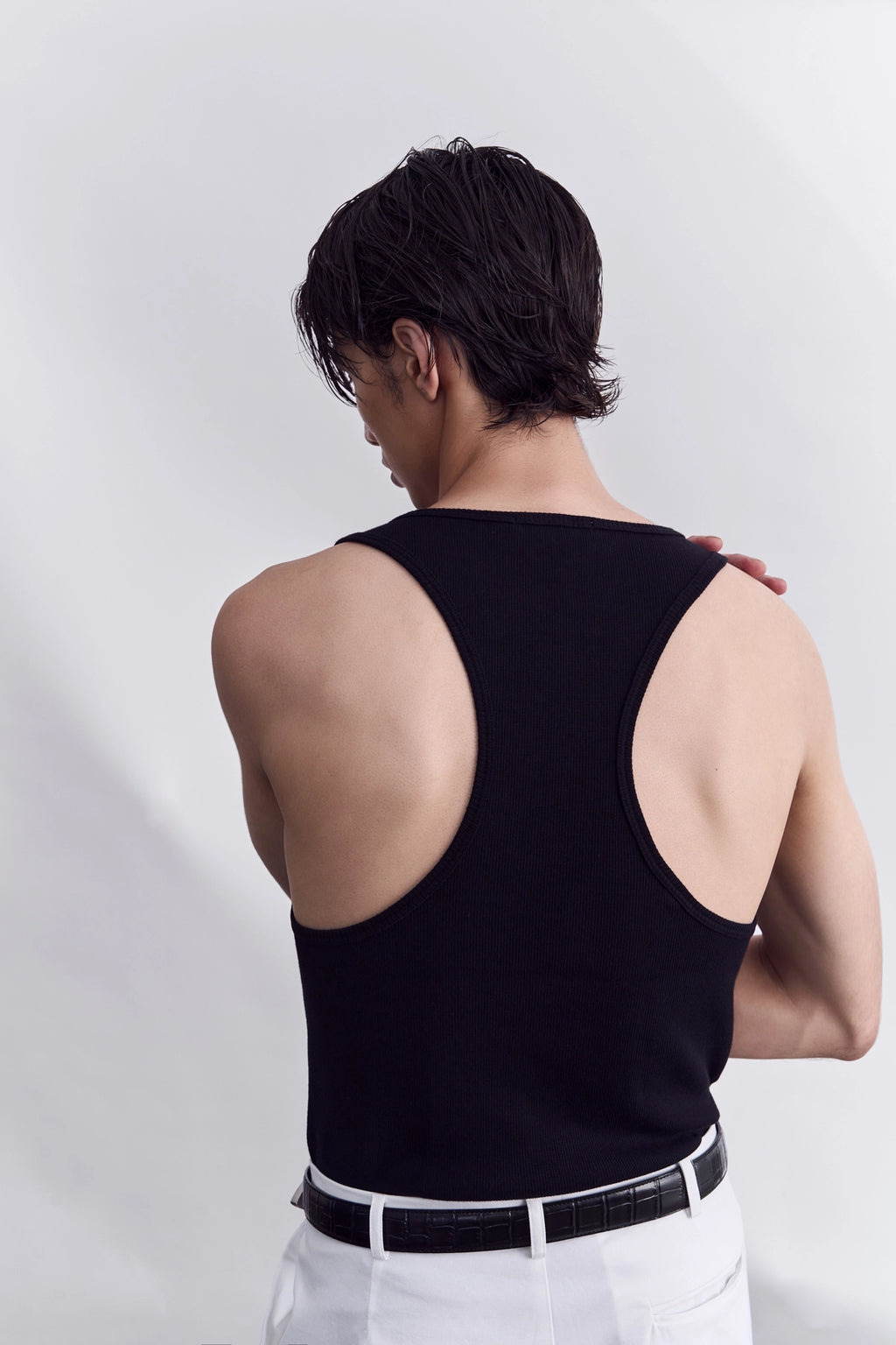 Model wearing the black organic cotton tank top from Studio Luho.