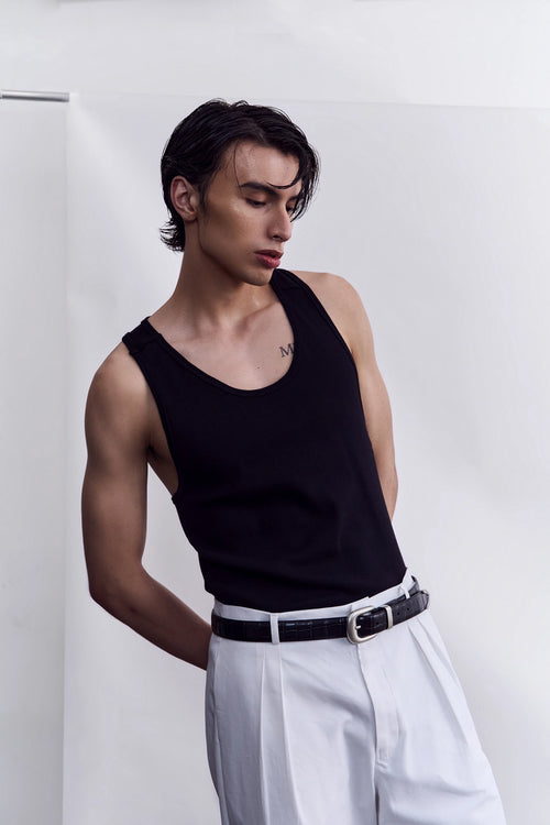 Model wearing the black organic cotton tank top from Studio Luho.