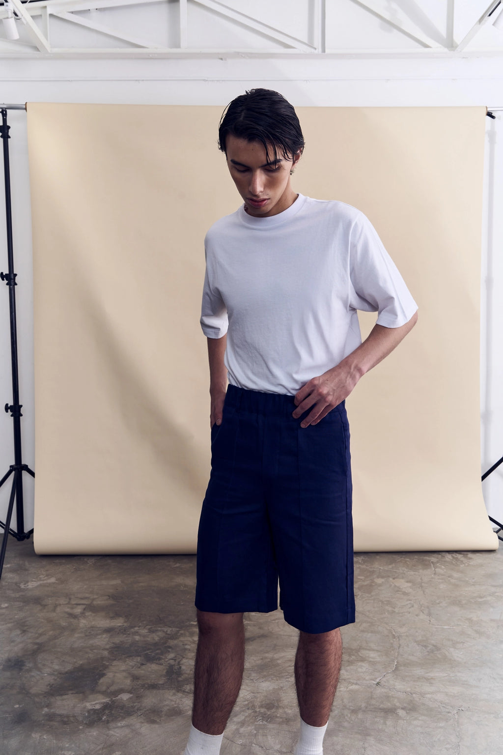 Model wearing the relaxed fit navy linen shorts from Studio Luho.