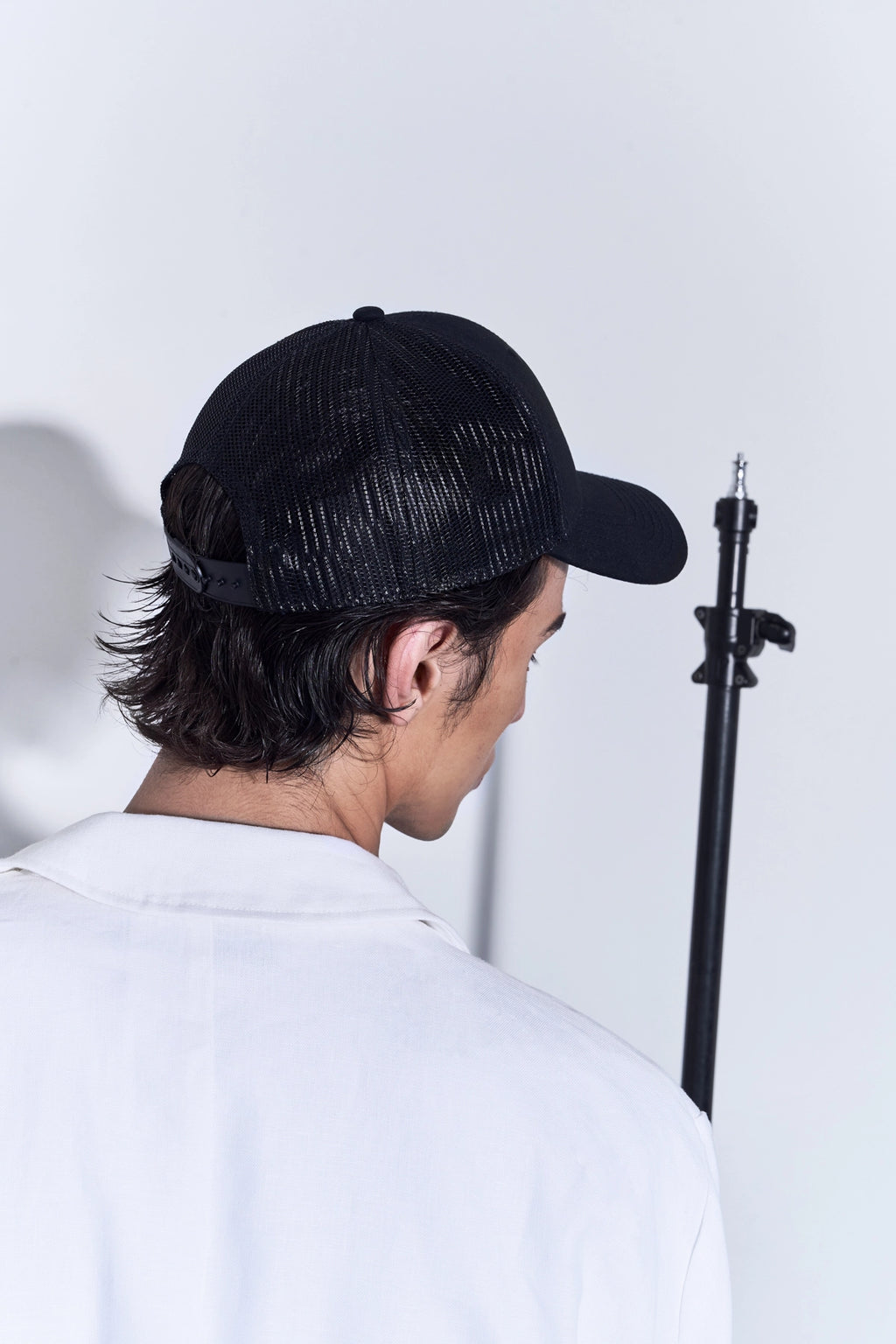 Model wearing the Studio Luho Trucker Cap.