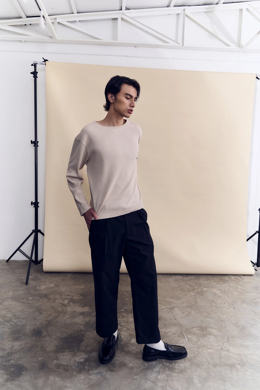 Model wearing the sand waffle knit long sleeve as a layering piece by Studio Luho.